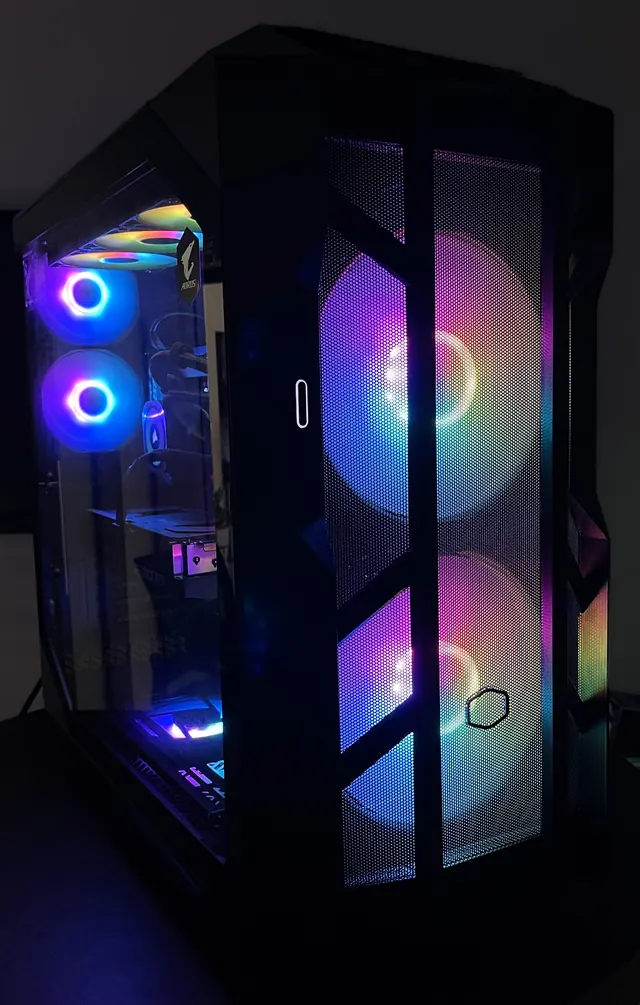Custom PC tower with RGB fans behind a mesh front panel