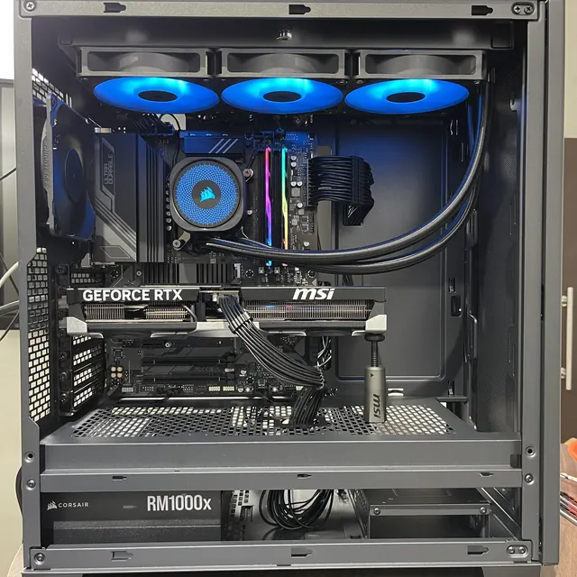 Custom PC with an RTX graphics card, AIO cooler and blue-lit fans
